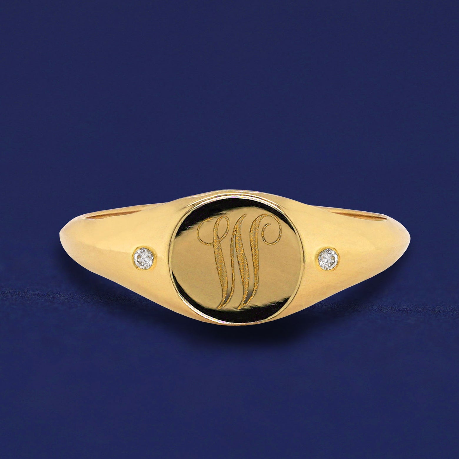 A solid yellow gold Diamond Signet Ring with the initial W engraved on the top in a script font