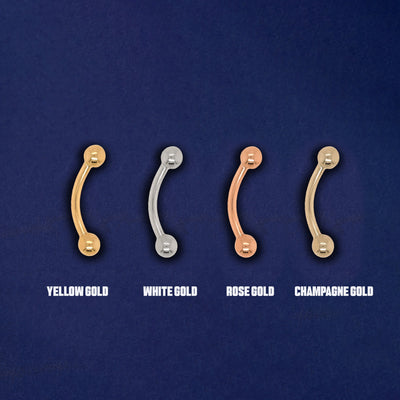 Four versions of the Small Curved Barbell Piercing in yellow, white, rose and champagne gold