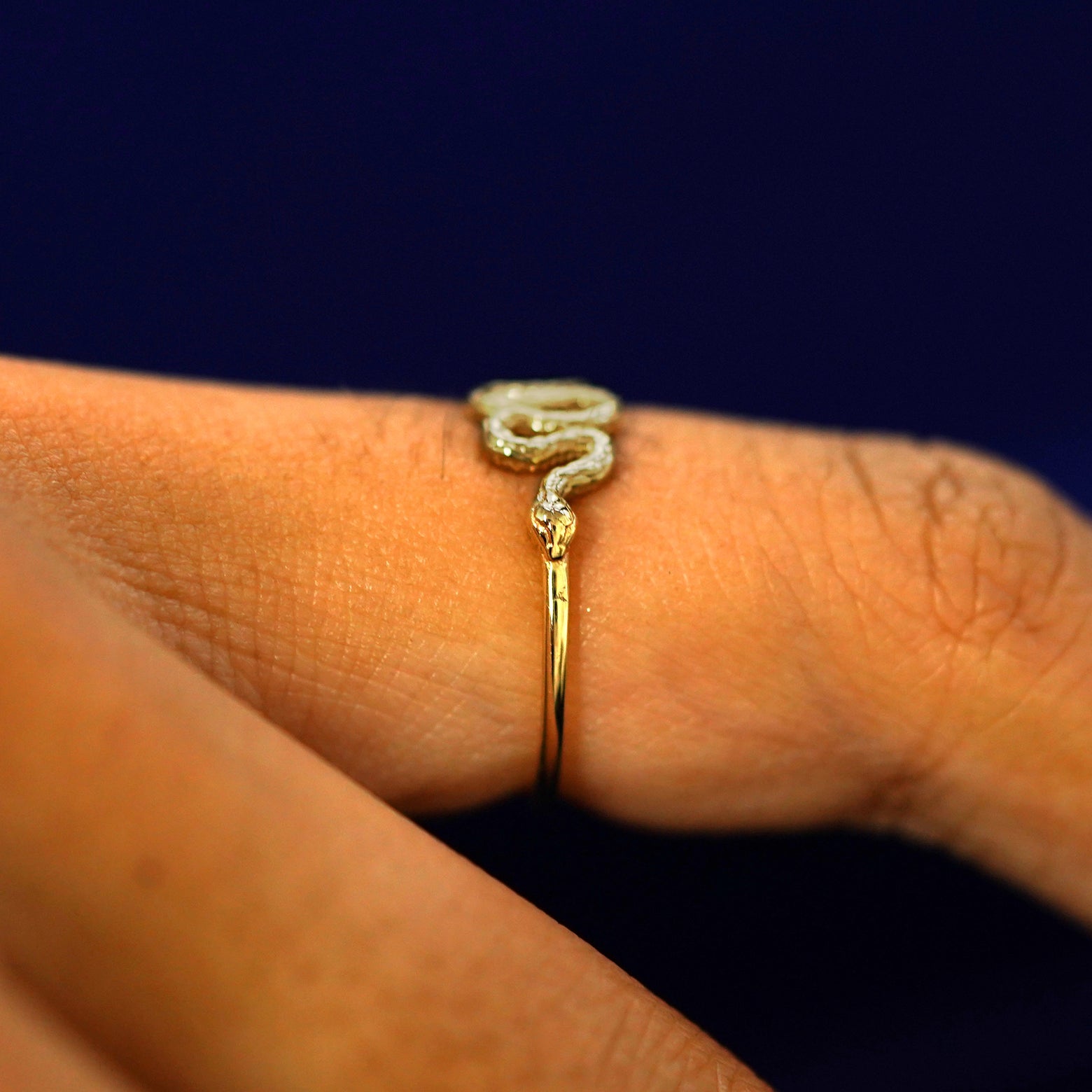 Side view of a Snake Ring on a model's finger