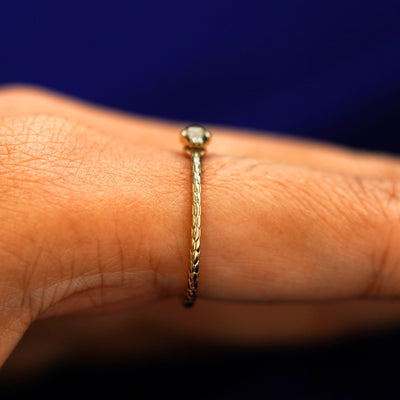 Side view of a Ouroboros Snake Ring on a model's finger showing the snakes face 