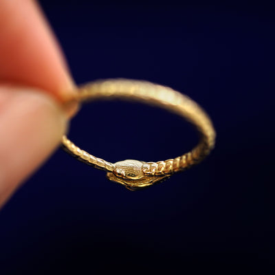 Underside view of a solid 14k gold Ouroboros Snake Ring to show under the snake's head