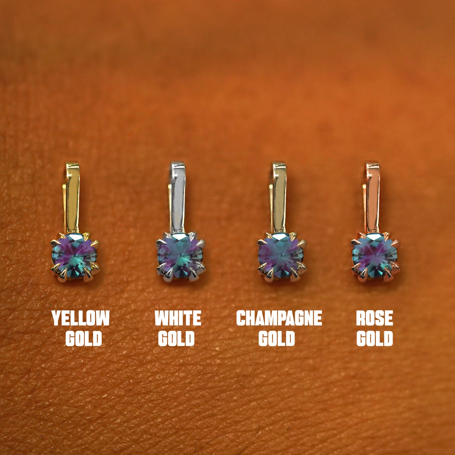 Four versions of the Alexandrite Charm shown in options of yellow, white, rose, and champagne gold