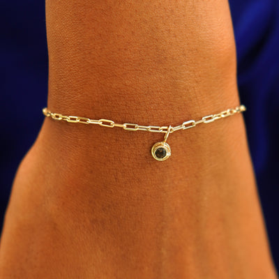 Close up view of a model's wrist wearing a yellow gold Infinity Coffee Cup on a Butch Bracelet