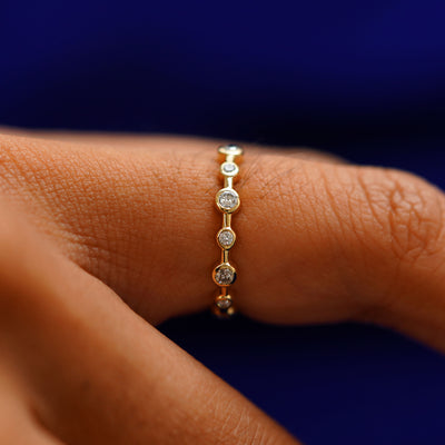 Side view of a Infinity Diamond Ring on a model's finger