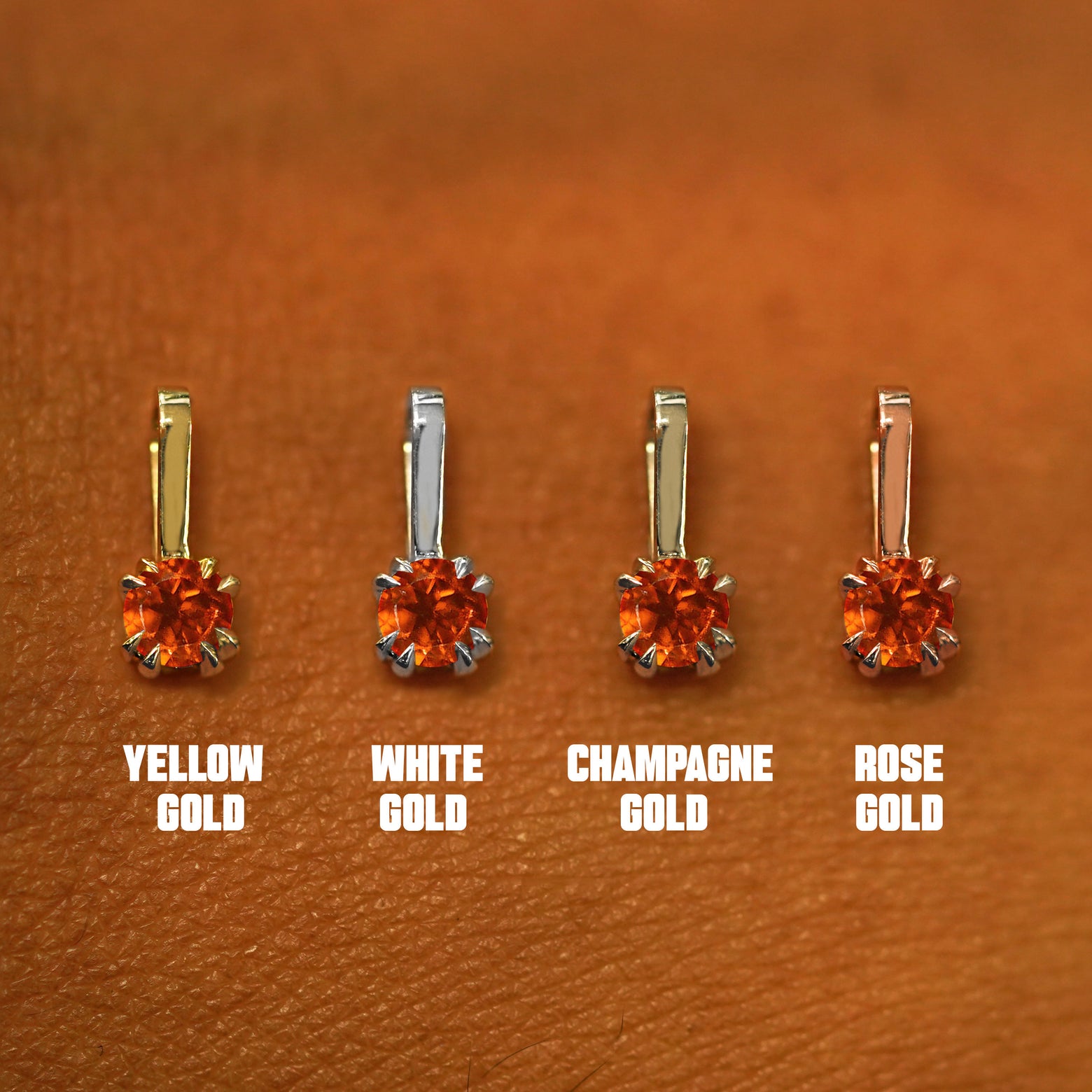 Four versions of the Fire Opal Charm shown in options of yellow, white, rose, and champagne gold