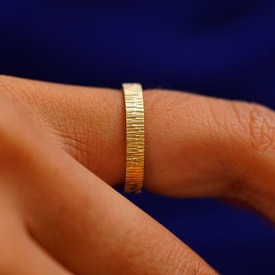 Side view of a Industrial Wood Band on a model's finger