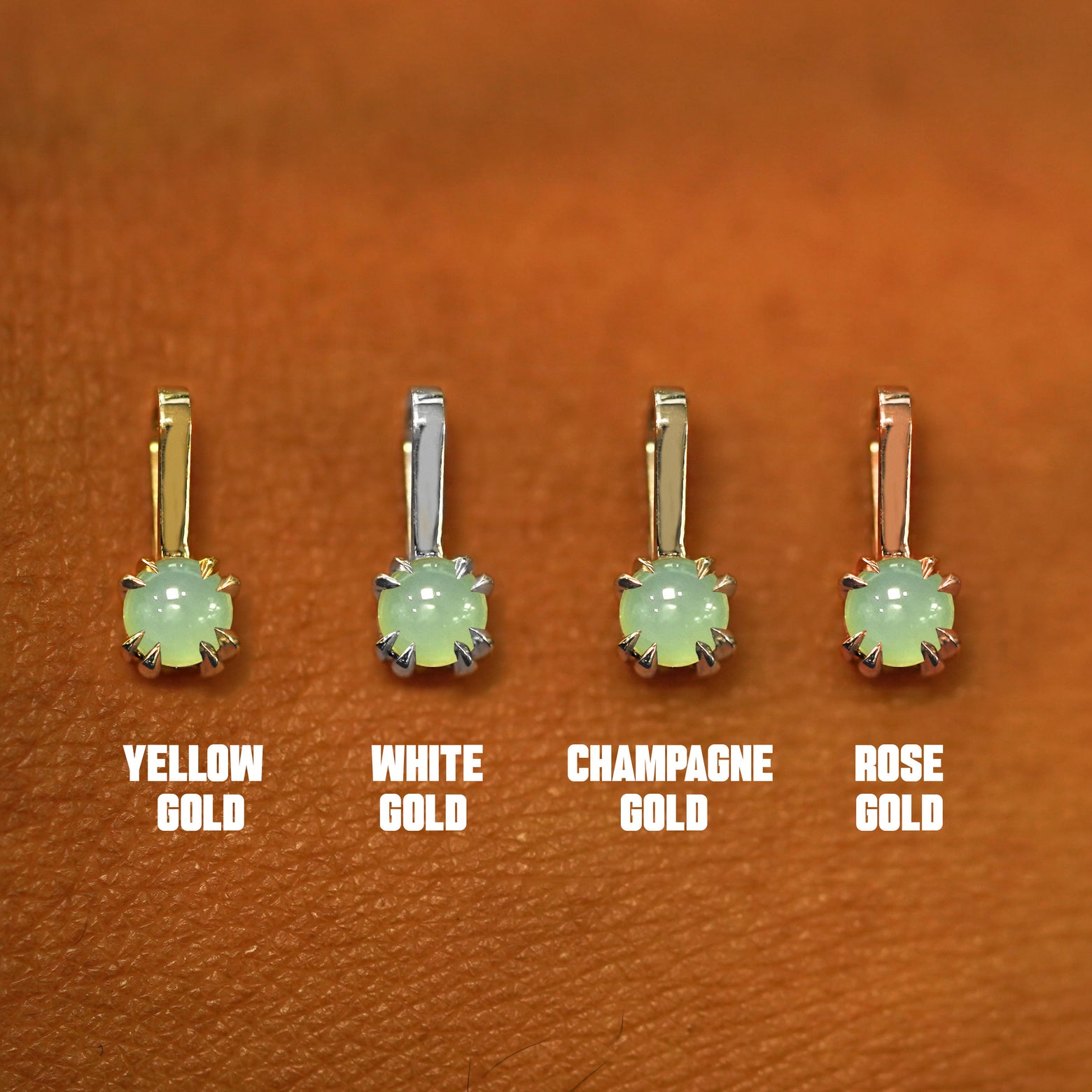 Four versions of the Jade Charm shown in options of yellow, white, rose, and champagne gold