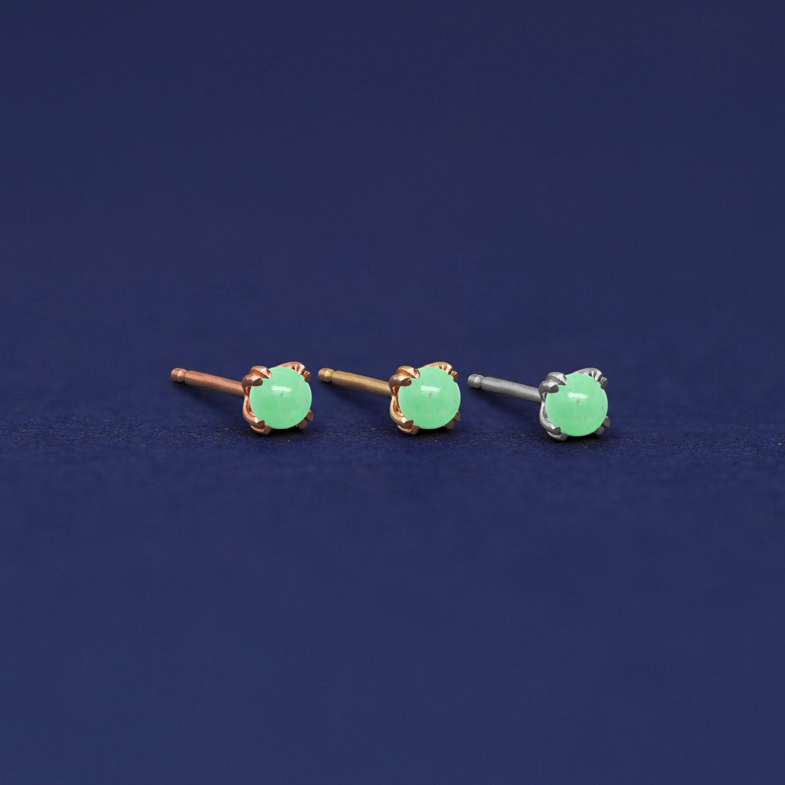 Three versions of the Green Jade Earring shown in options of rose, yellow, and white gold