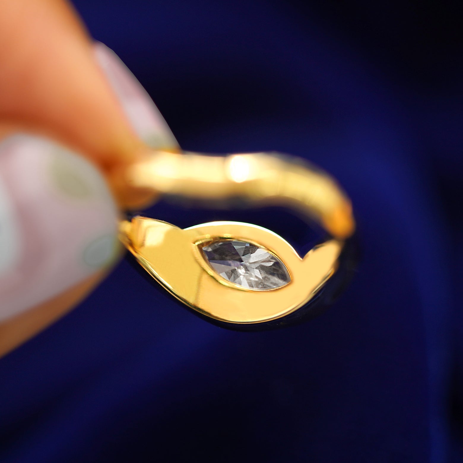 Underside view of a solid 14k gold Marquise Lab Diamond Melted Ring to show diamond setting