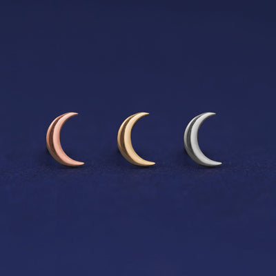 Three versions of the Moon Earring shown in options of yellow, white, and rose gold