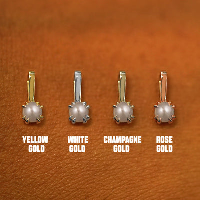 Four versions of the Pearl Charm shown in options of yellow, white, rose, and champagne gold