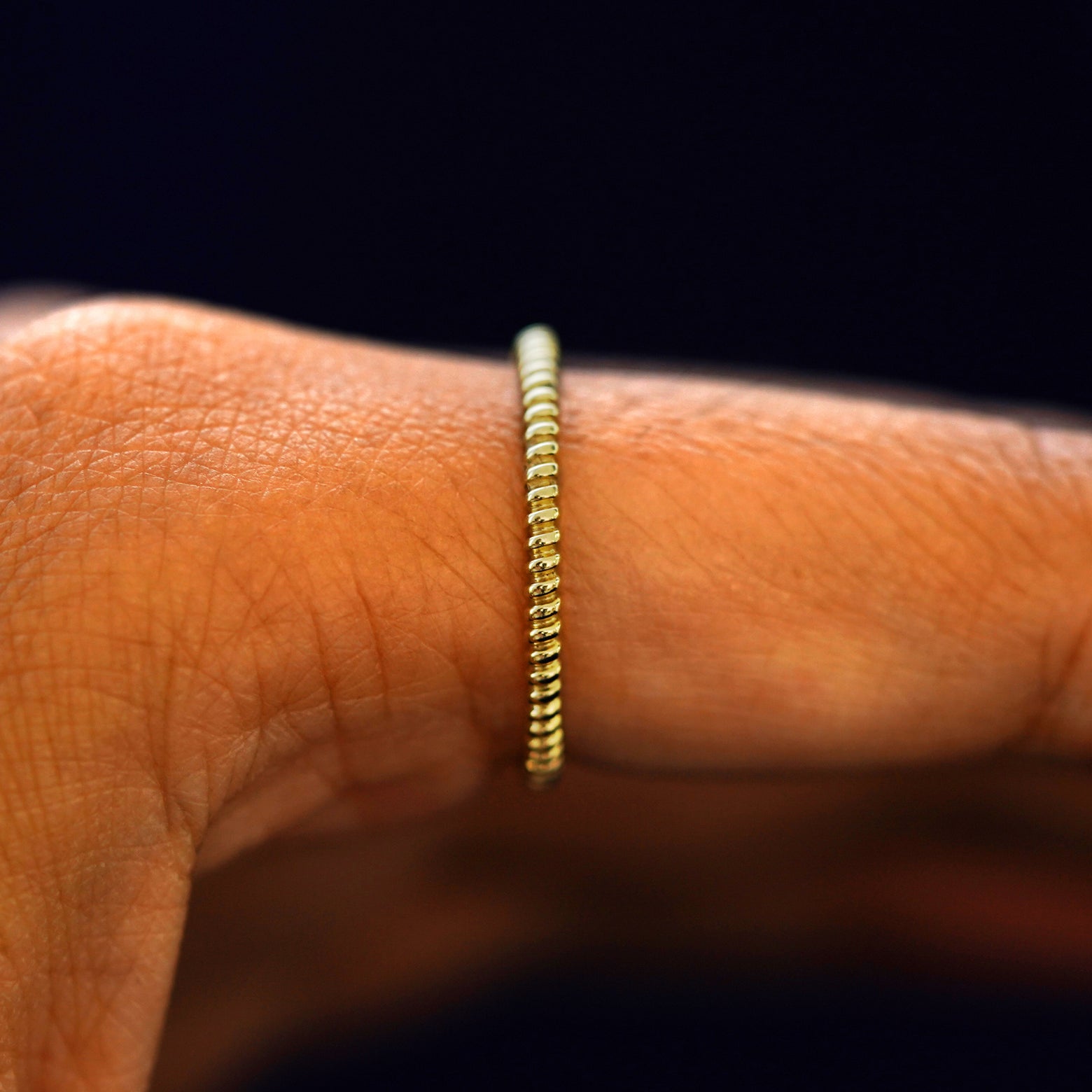 Side view of a Rope Ring on a model's finger