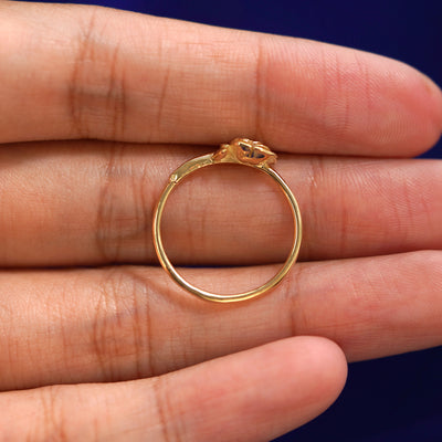 A yellow gold Rose Ring in a model's hand showing the thickness of the band