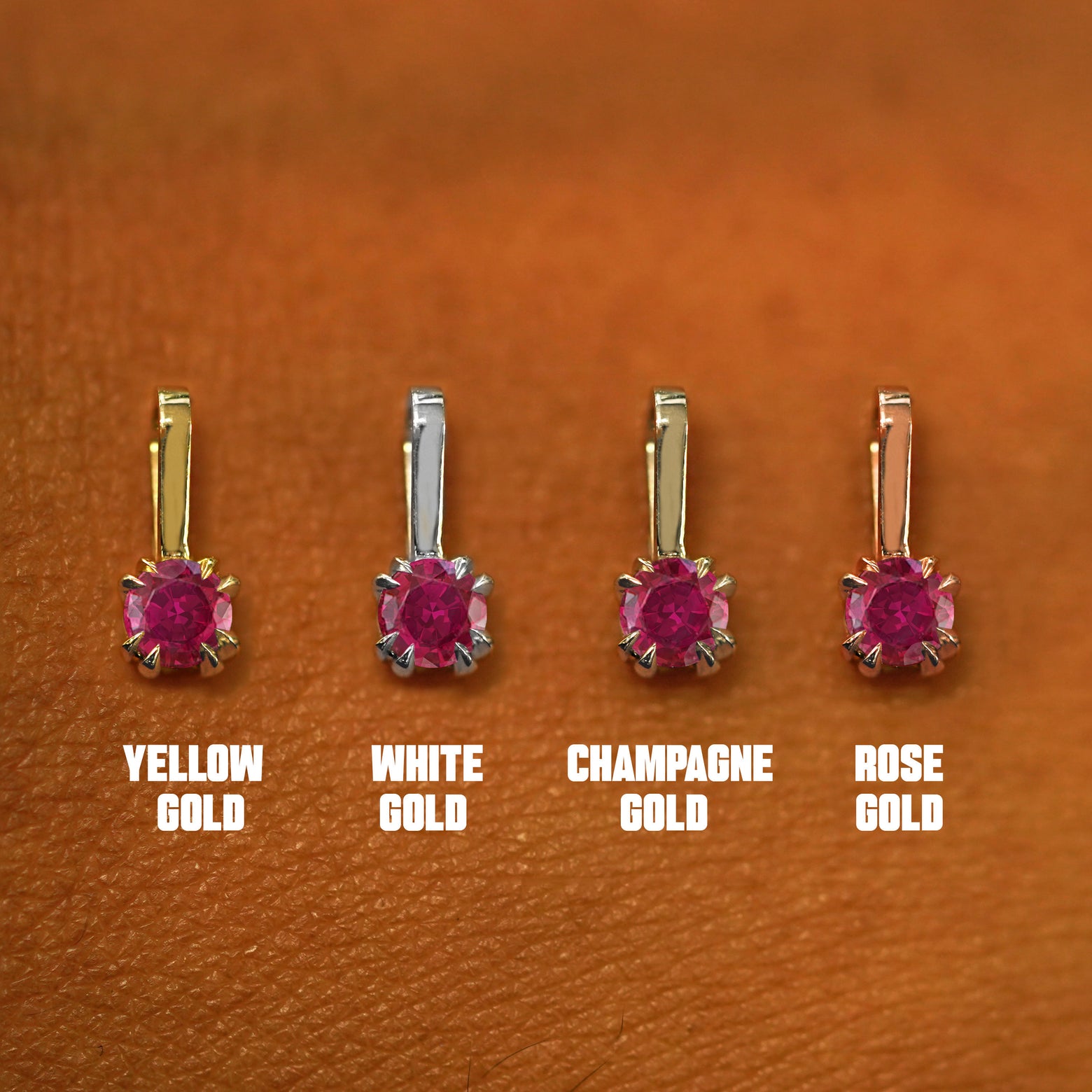 Four versions of the Ruby Charm shown in options of yellow, white, rose, and champagne gold