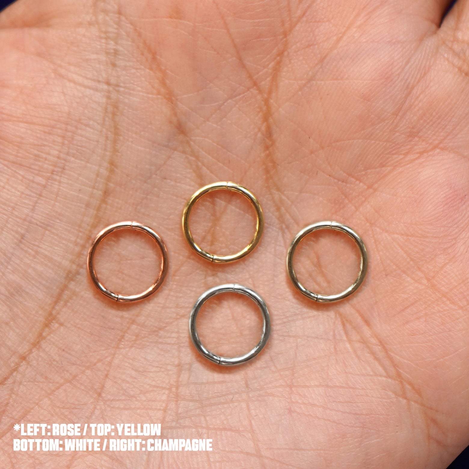 Four versions of the Small Seamless Huggie Hoop / Piercing shown in options of rose, yellow, champagne, and white gold