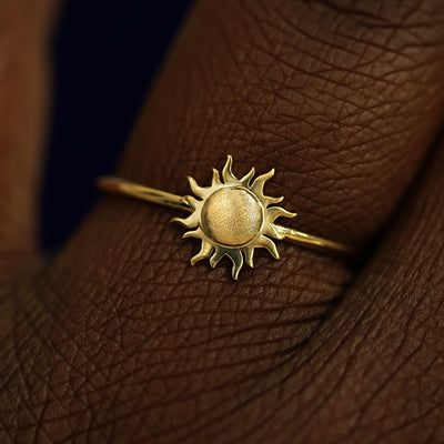 Close up view of a model's fingers wearing a 14k yellow gold Sun Ring