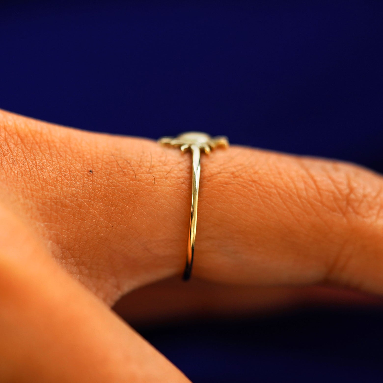 Side view of a Sun Ring on a model's finger