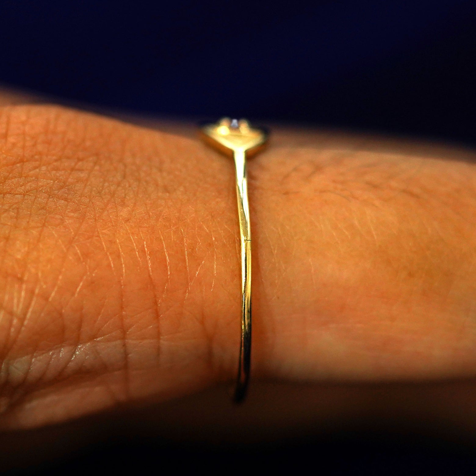 Side view of a Diamond Evil Eye Ring on a model's finger