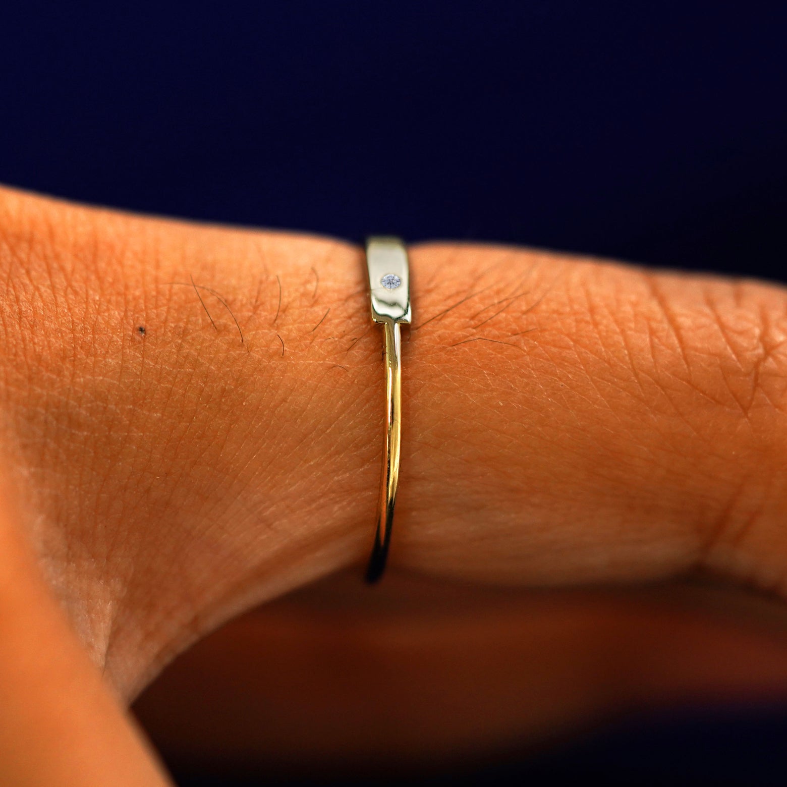 Side view of a Diamond Gemstone Bar Ring on a model's finger