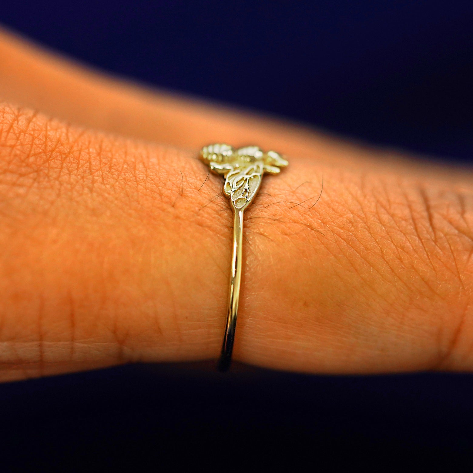 Side view of a Bee Ring on a model's finger