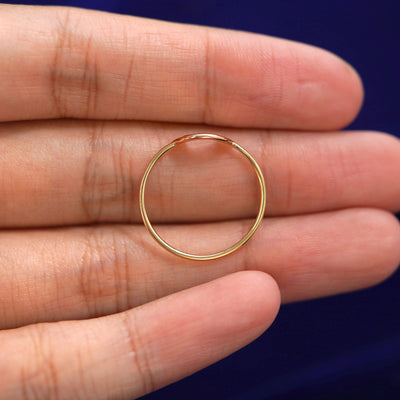 A Rainbow Ring in a model's hand showing the thickness of the band