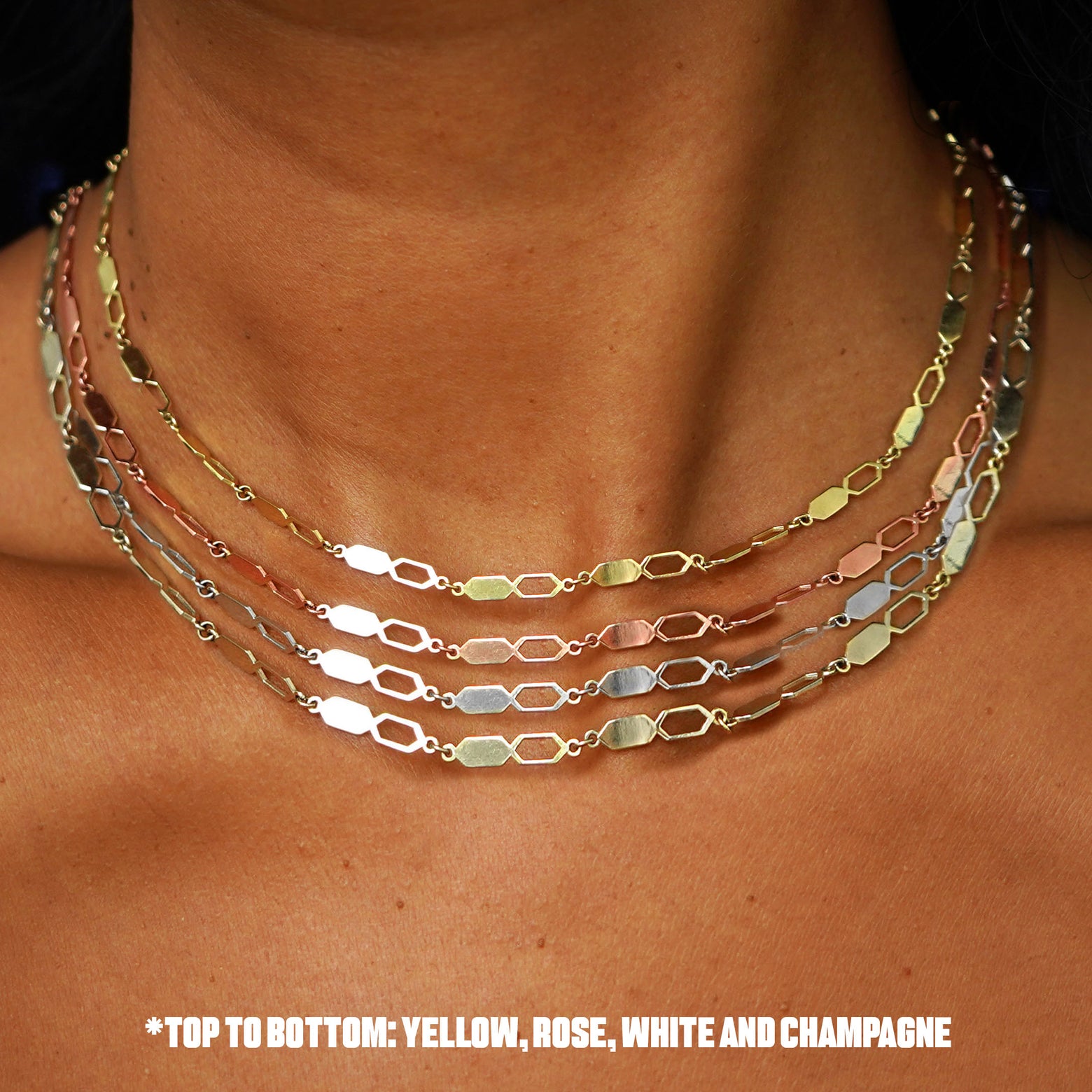 Close up view of a model's neck wearing a four versions of the Tanlah Chain in yellow, rose, white, and champagne gold