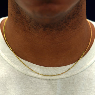 A model's neck wearing a yellow gold Thick Cable Chain