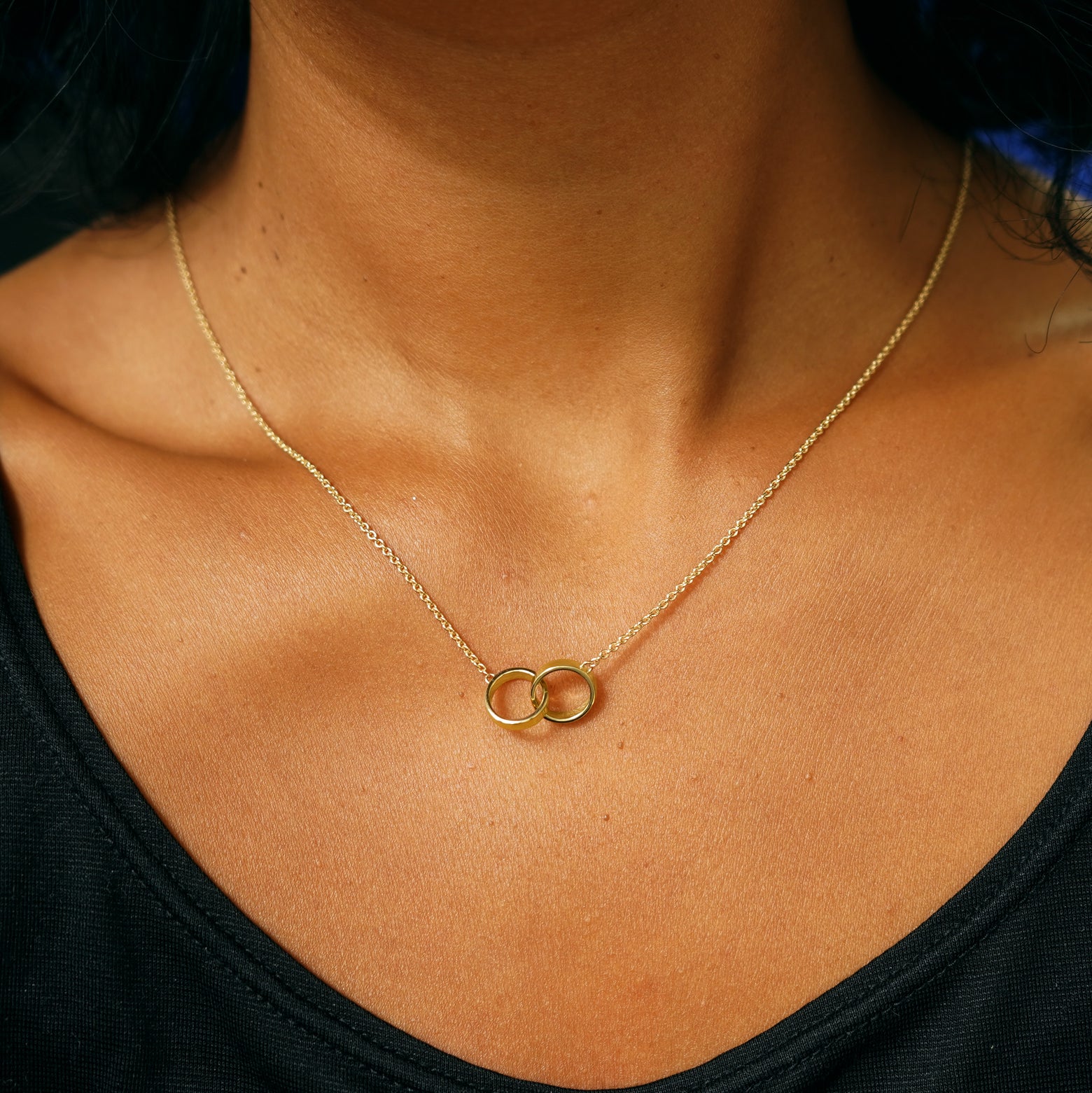 A model's neck wearing a yellow gold Bound Together Necklace