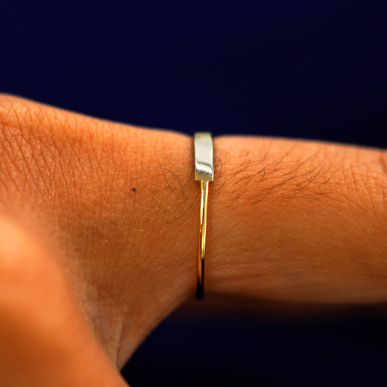 Side view of a Diamond Gemstone Bar Ring on a model's finger showing the plain corner