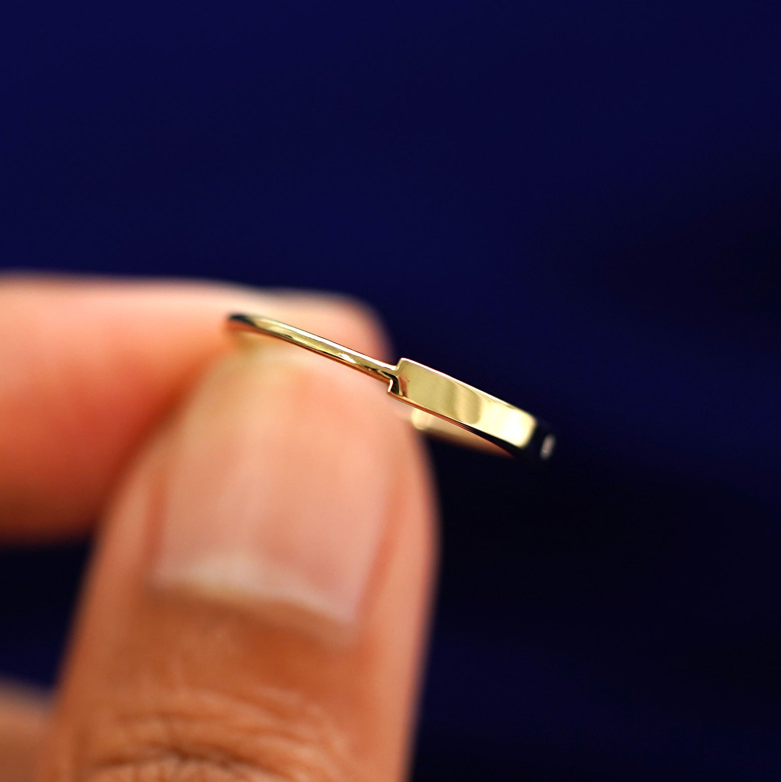 A model holding a Diamond Gemstone Bar Ring tilted to show the side of the ring