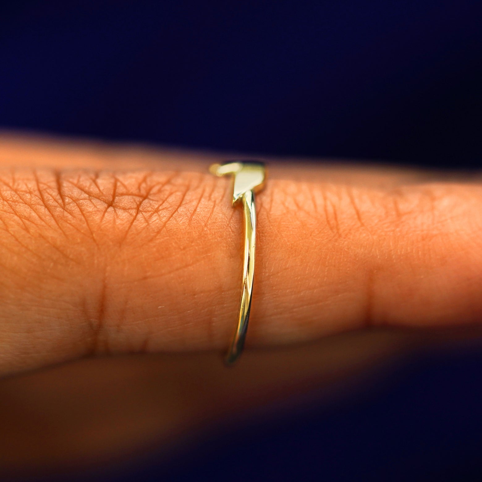 Side view of a Lightning Bolt Ring on a model's finger