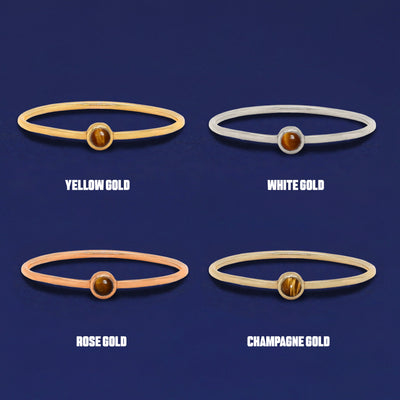 Four versions of the Tiger Eye Ring shown in options of yellow, white, rose and champagne gold