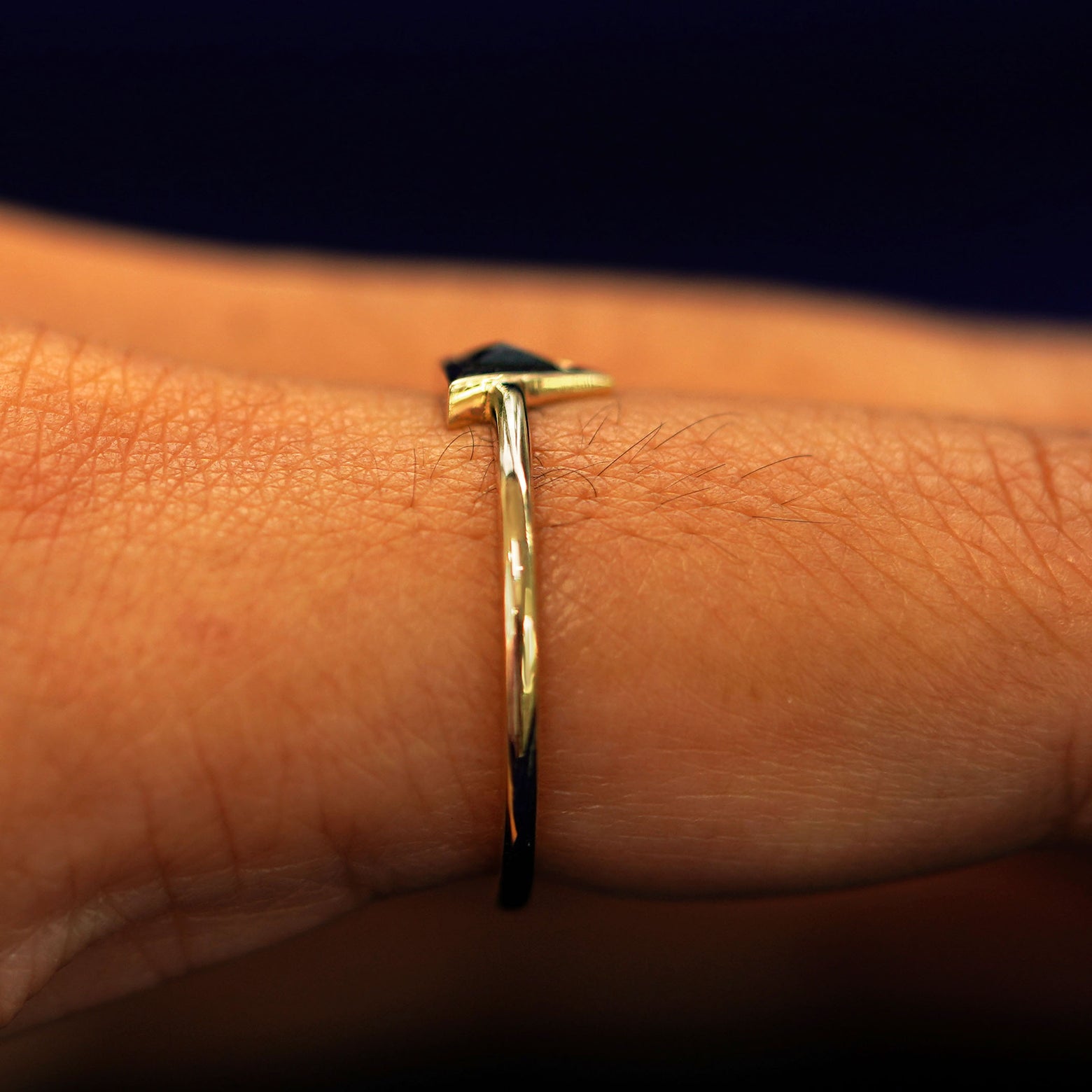 Side view of a Trillion Black Diamond Ring on a model's finger to show details