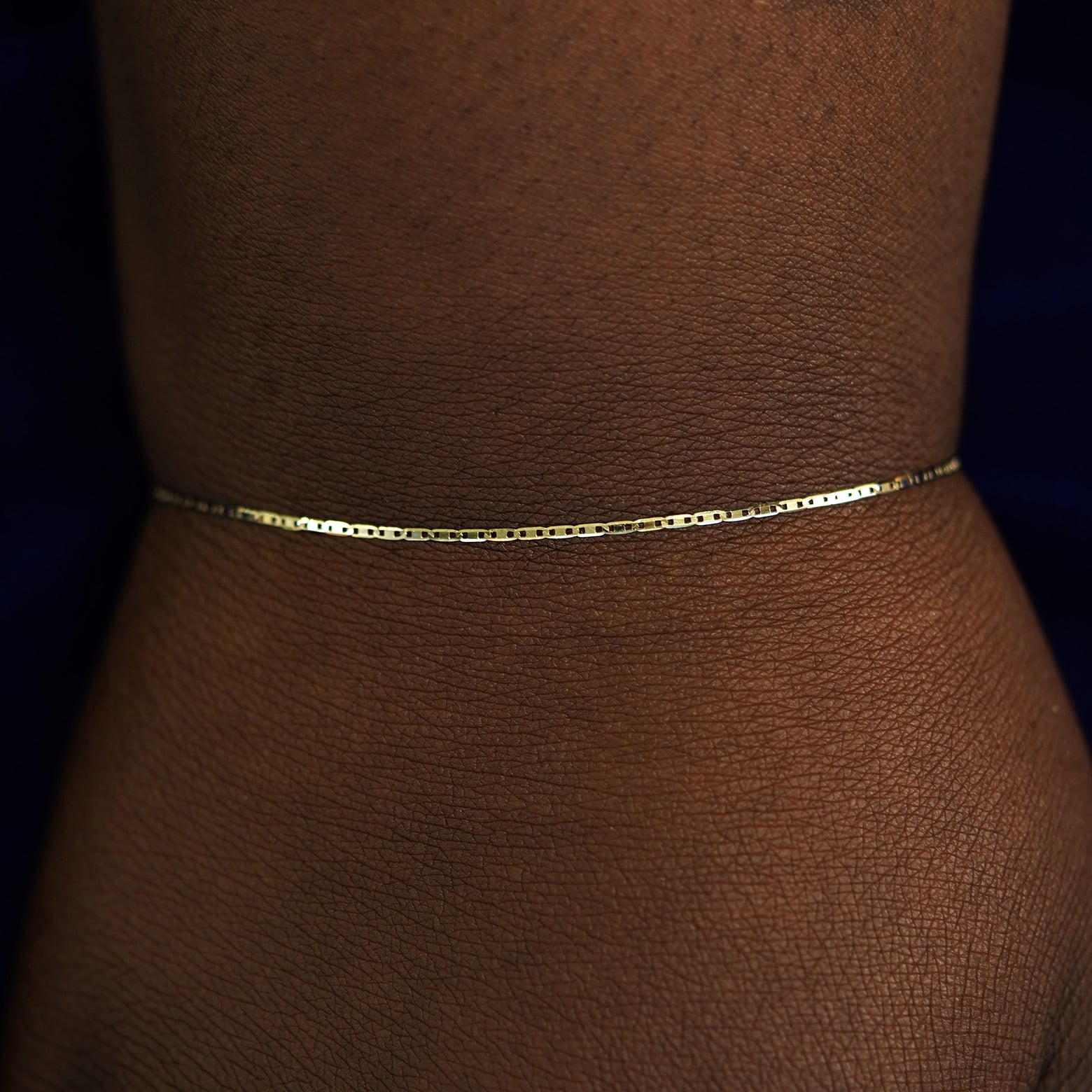 A model's wrist wearing a yellow gold Valentine Bracelet