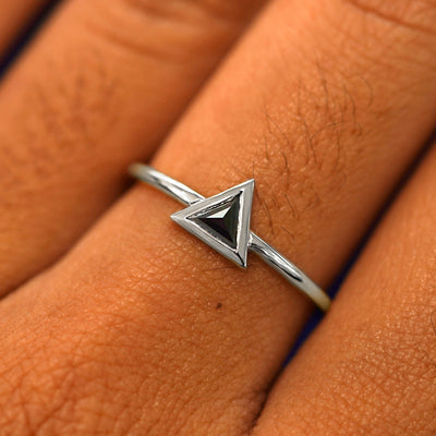 Close up view of a model's fingers wearing a 14k white gold Trillion Black Diamond Ring