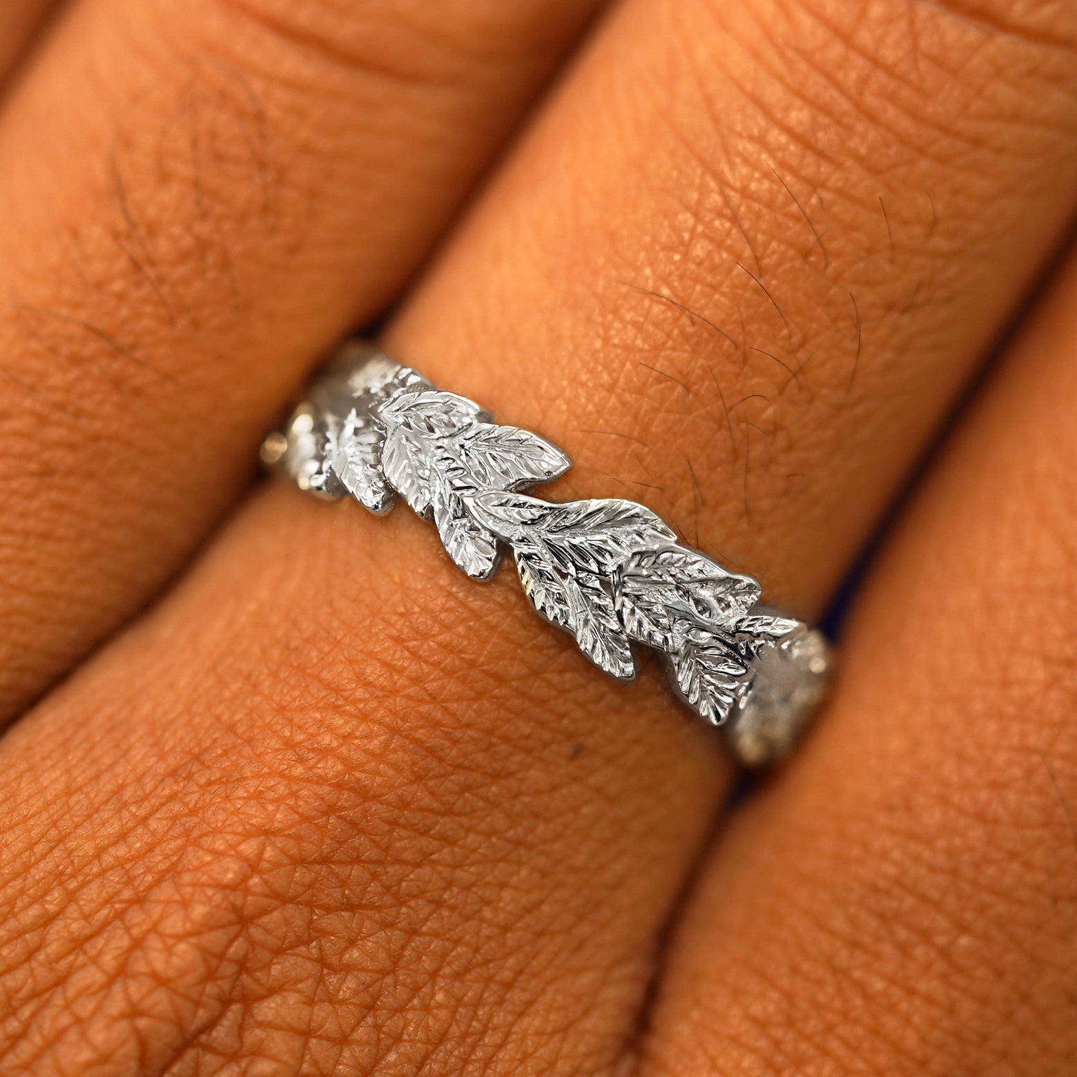 Close up view of a model's fingers wearing a 14k white gold Double Leaves Band