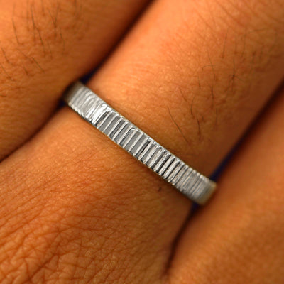 Close up view of a model's fingers wearing a 14k white gold Edge Band