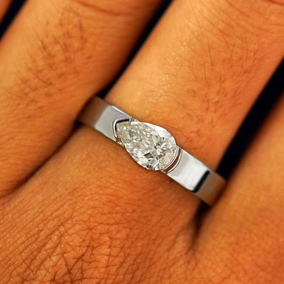 Close up view of a model's fingers wearing a 14k white gold Lab Diamond Pear Ring