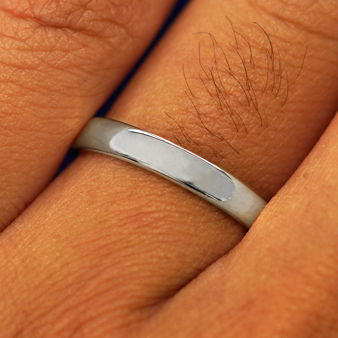 Close up view of a model's fingers wearing a 14k white gold Mix Mirror Band