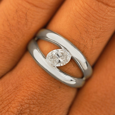 Close up view of a model's fingers wearing a 14k white gold Oval Lab Diamond Tension Ring