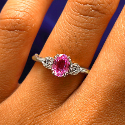 Close up view of a model's fingers wearing a 14k white gold Pink Sapphire Roses Ring