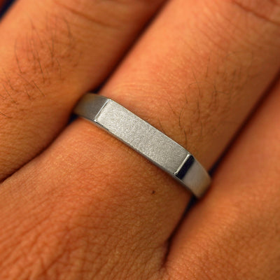 Close up view of a model's fingers wearing a 14k white gold Rectangular Signet Ring