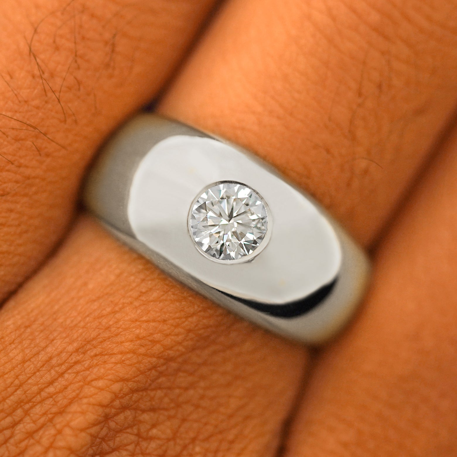 Close up view of a model's fingers wearing a 14k white gold Round Lab Diamond Puffy Signet Ring