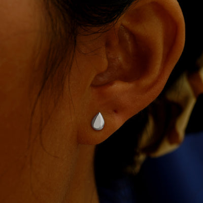 A model's ear wearing a 14k white gold Teardrop Earring