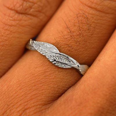 Close up view of a model's fingers wearing a 14k white gold Thick Leaves Band