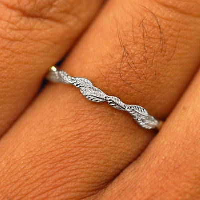 Close up view of a model's fingers wearing a 14k rose gold Thin Leaves Band