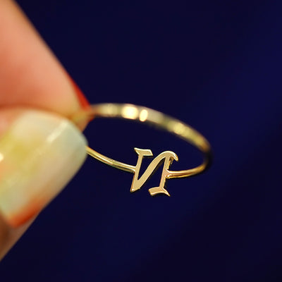 A model holding an Initial Ring with the letter N to show the underside view