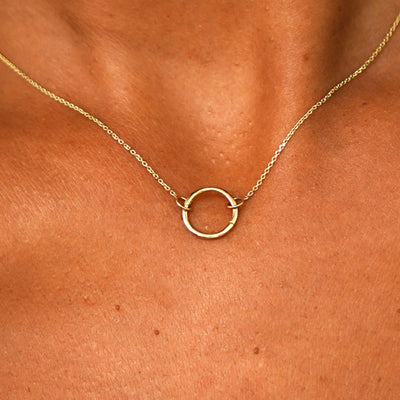 Close up view of a model's neck wearing a solid 14k yellow gold Lockless Cable Necklace