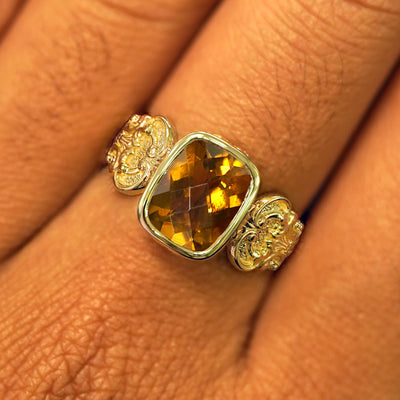 Close up view of a model's fingers wearing a yellow gold whiskey quartz Royalty Ring