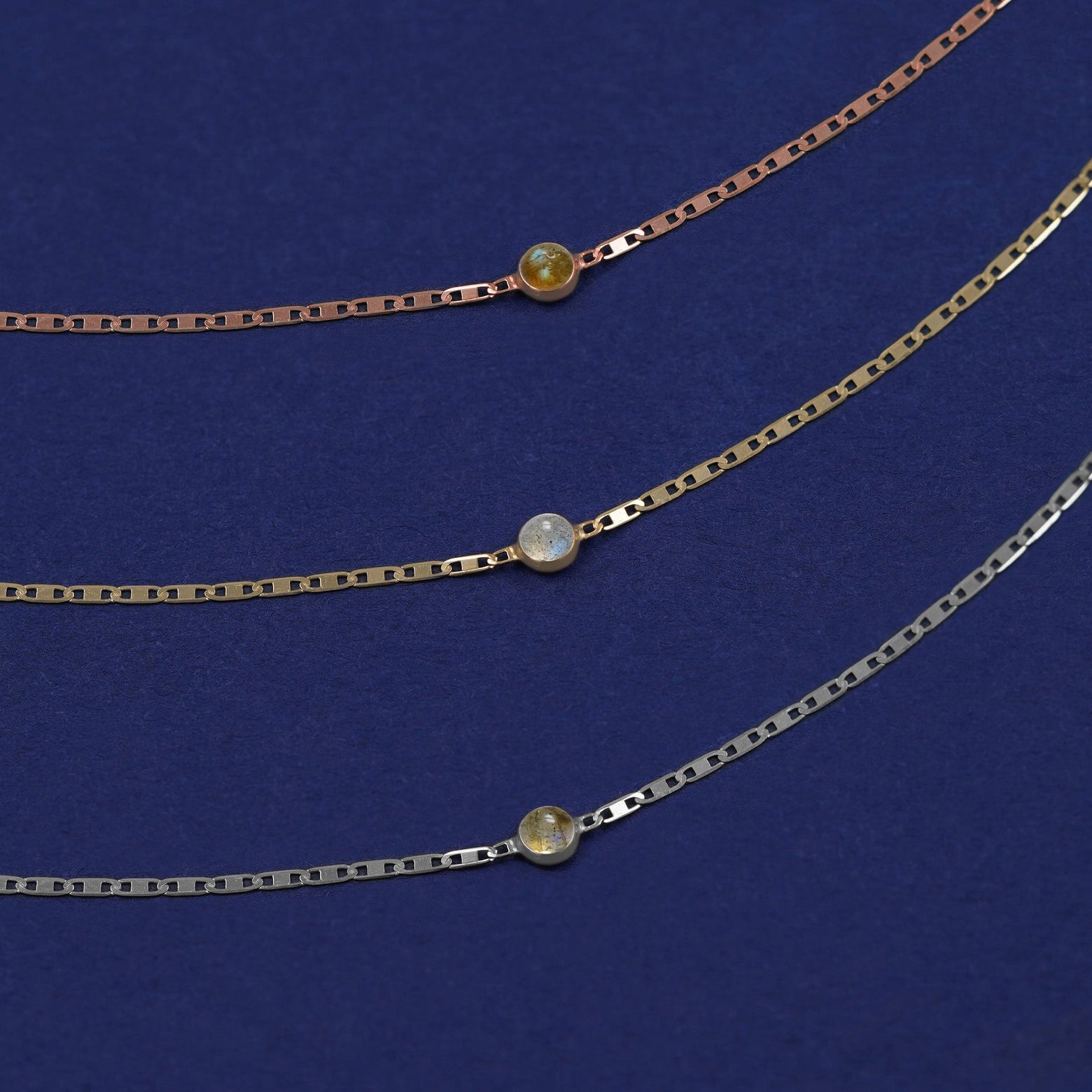 Three Labradorite Bracelets shown in options of rose, yellow, and white gold